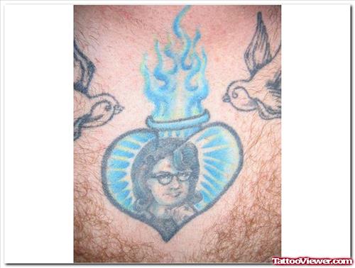 Blue Ink Flaming Heart Tattoo