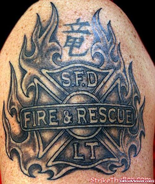 Awesome Grey Ink Firefighter Logo Tattoo On Shoulder