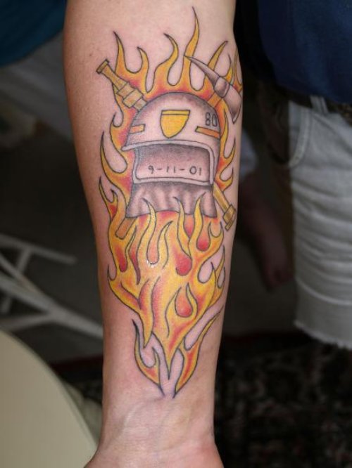 Helmet In Fire Tattoo On Arm
