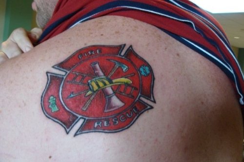 Red Ink Firefighter Logo Tattoo On Upper Shoulder