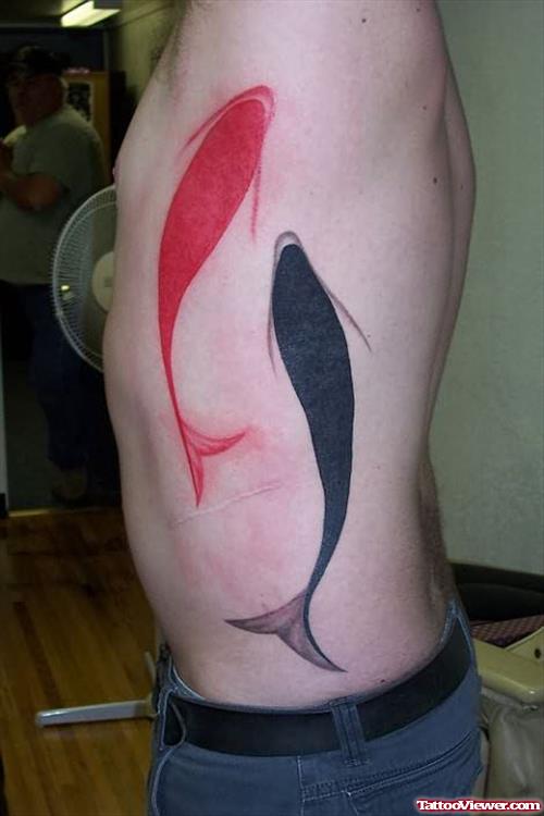 Red And Black Fish Tattoo On Rib