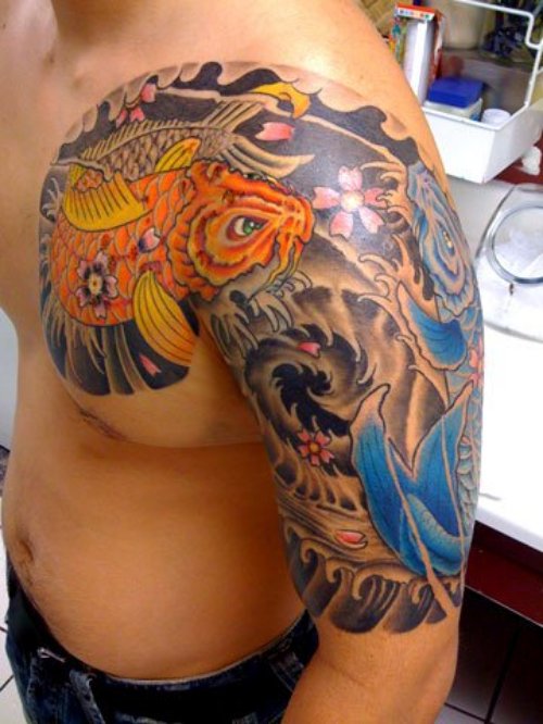 Amazing Colored Fish Tattoo On Chest And Half Sleeve