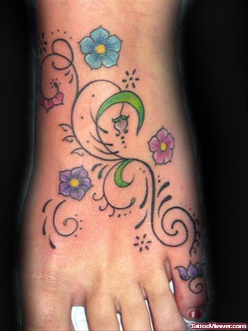 Tribal And Colored Flowers Tattoos On Left Foot