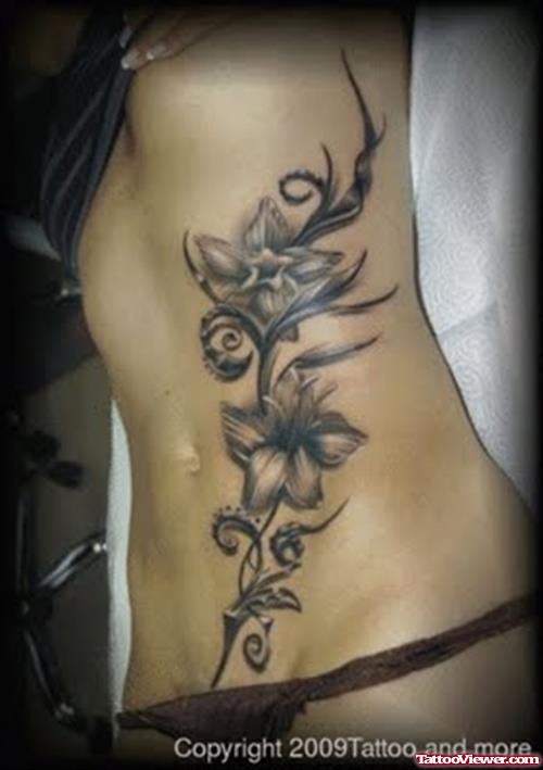 Grey Ink Flowers Tattoo On Side Rib