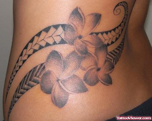 Polynesian And Flower Tattoos On Lowerback