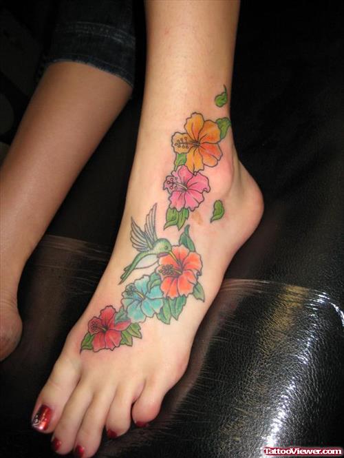 Colored Hummingbird And Flower Tattoos On Left Foot