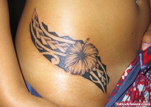 Black Ink Hawaiian And Flower Tattoo On Side