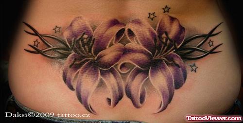 Tribal And Flower Tattoos On Lowerback