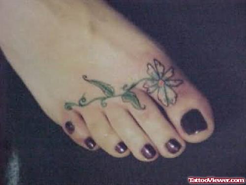 Girl Showing Flower Tattoo On Foot