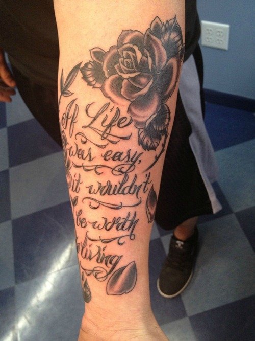 Grey Ink Lettering and Flower Tattoo On Arm
