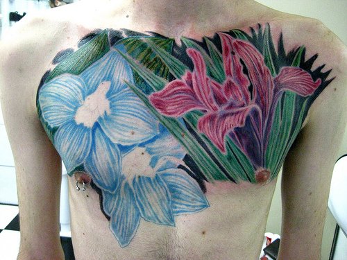 Colored Flowers Tattoos On Man Chest