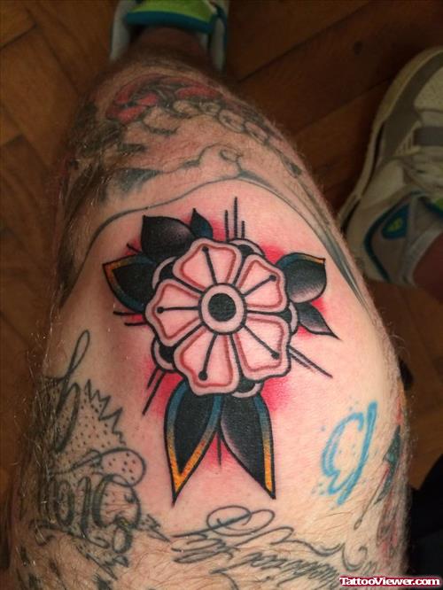 colorful flower with petals tattoo on knee