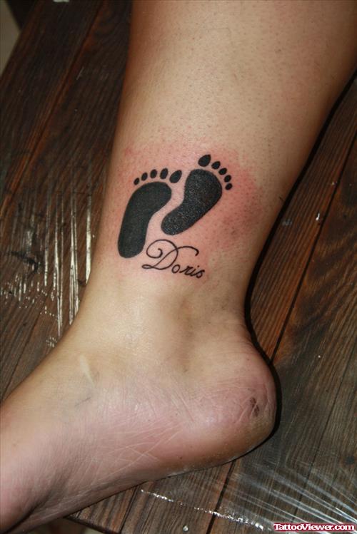 Black Ink Foot Prints Tattoo On Ankle