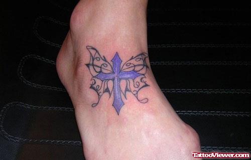 Purple Ink Cross Tattoo On Foot