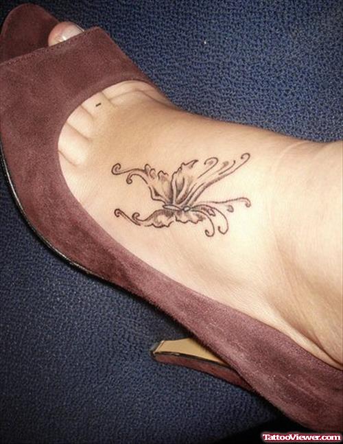 Grey Ink Small Butterfly Foot Tattoo