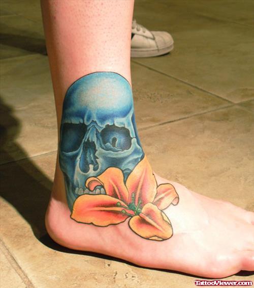 Blue Ink Skull And Lily Flower Foot Tattoo