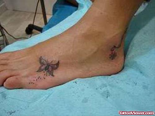 Grey Ink Foot Tattoo On Left Foot