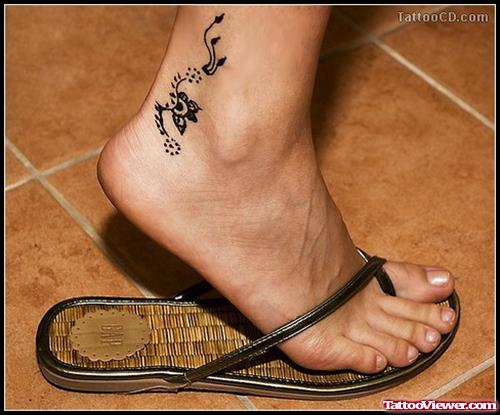 Black Ink Flower Tattoo On Girl Foot