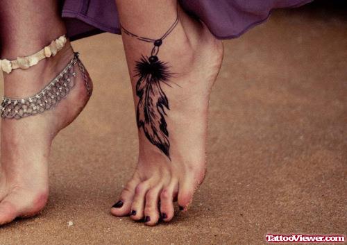 Black Ink Feather Tattoo On Left Foot