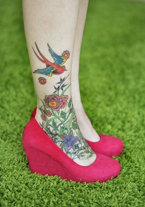 Colored Flying Bird And Flowers Foot Tattoo