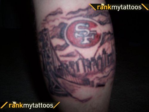 Grey Ink Football Tattoo On Back Leg