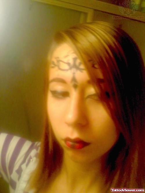 Eyeliner And Ink Tattoo On Forehead