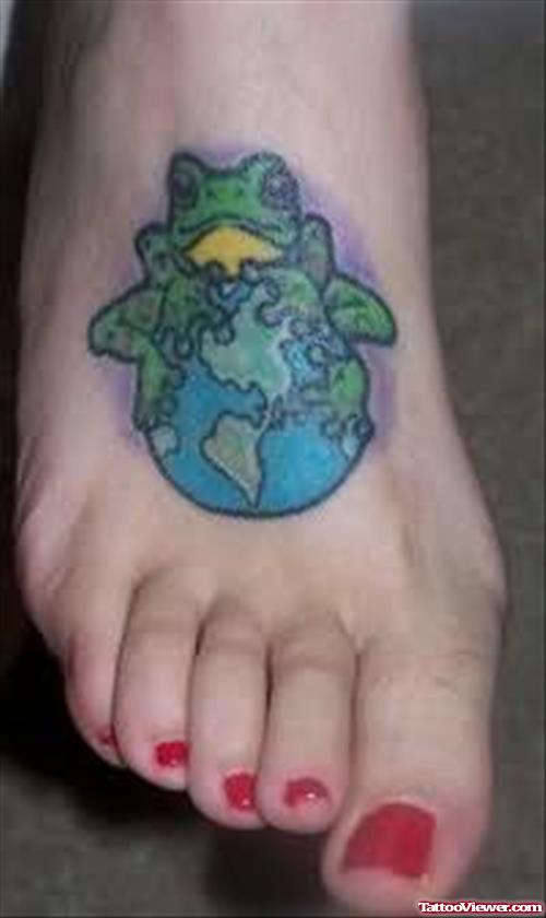Frog Sitting On Earth Tattoo On Foot