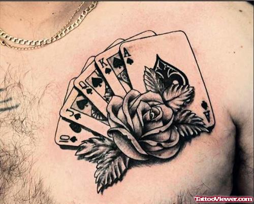 Grey Ink Rose Flower And Cards Gambling Tattoo On Man Chest