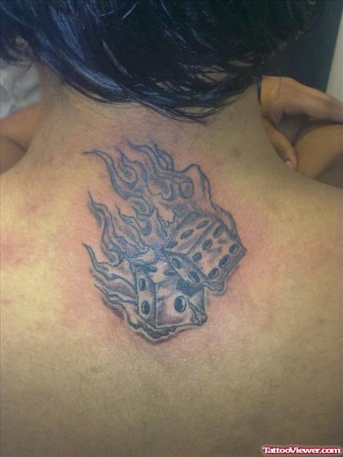 Grey Ink Flaming Dice Tattoo On Upperback
