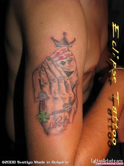 Grey Ink Praying Hand With Cards Gambling Tattoo On Arm