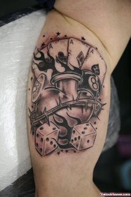Grey Ink Dice And Heart Gambling Tattoo On Bicep