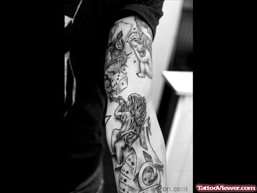 Grey Ink Cherub Angel Gambling Tattoo On Left Arm