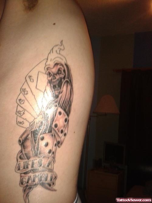 Grey Ink Cards and Dice With Banner Gambling Tattoo On Side Rib