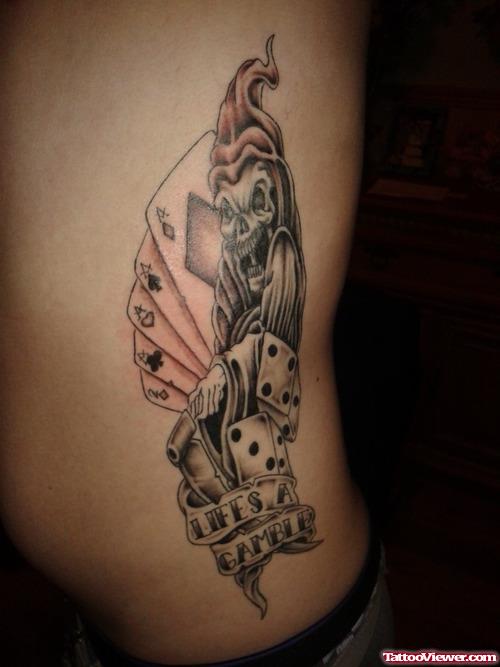 Grey Ink Dice And Cards Gambling Tattoo On Side Rib