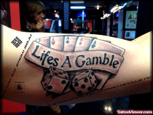Lifes A Gamble Tattoo On Biceps