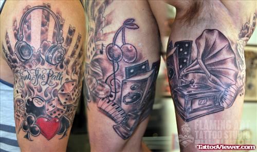 Grey Ink Music And Gambling Tattoos On Biceps