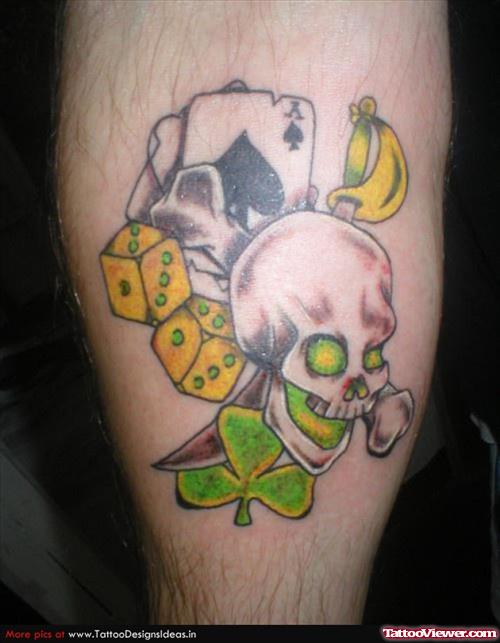 Grey Ink Skull And Gambling Dice Tattoos