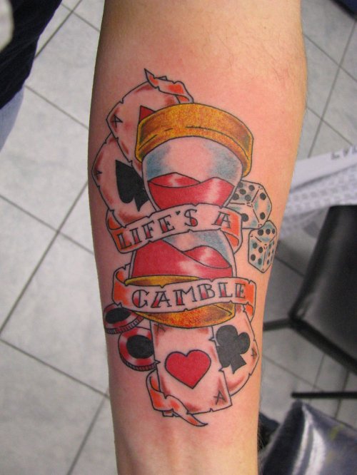 LifeвЂ™s A Gamble Banner and Heart Tattoo On Left Forearm