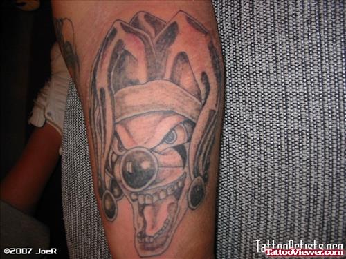 Grey Ink Joker Head Gangsta Tattoo On Sleeve