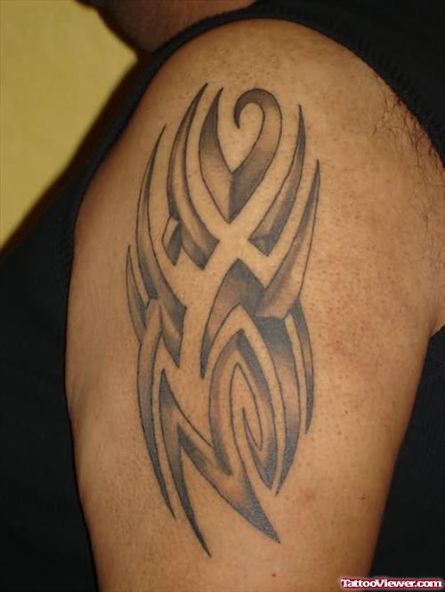 Grey Ink Tribal Gangsta Tattoo On Left Shoulder