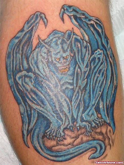 Blue Ink Gargoyle Tattoo On Bicep