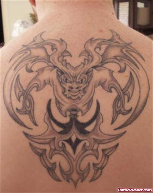 Grey Ink Tribal Gargoyle Tattoo On Upperback
