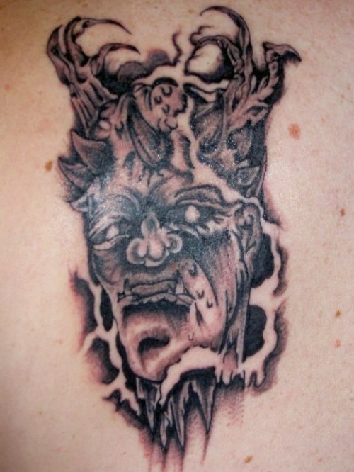 Grey Ink Ripped Skin Gargoyle Tattoo