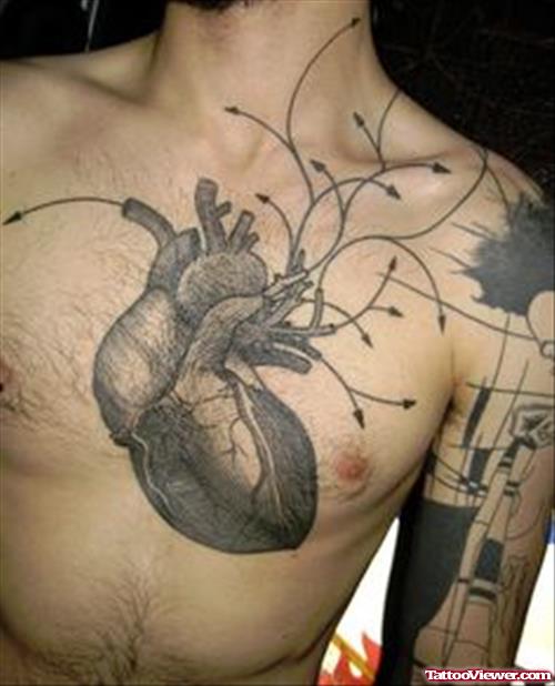 Grey Ink Heart Tattoo On chest And Geek Tattoo On Bicep