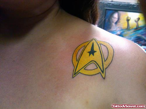 Yellow Ink Geek Tattoo On Left Collarbone