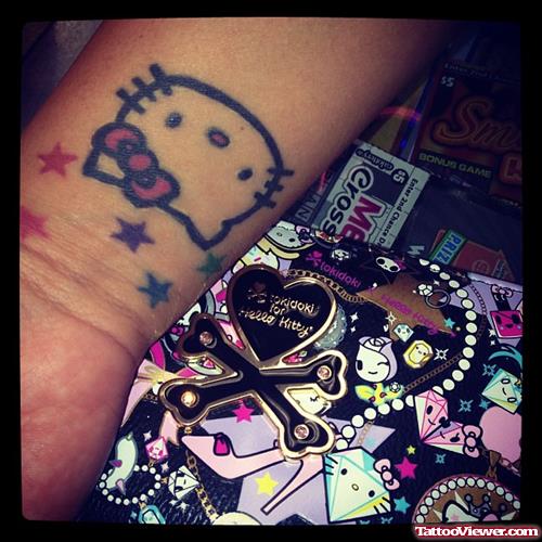 Colored Stars And Kitty Head Geek Tattoo On Wrist