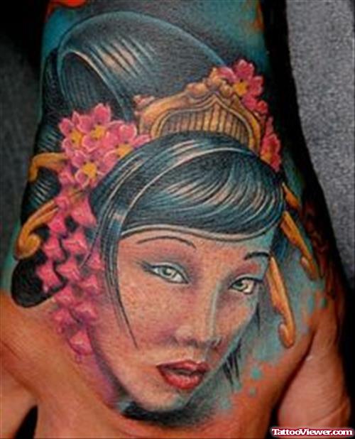 Colored Ink Geisha Head Tattoo On Right Hand