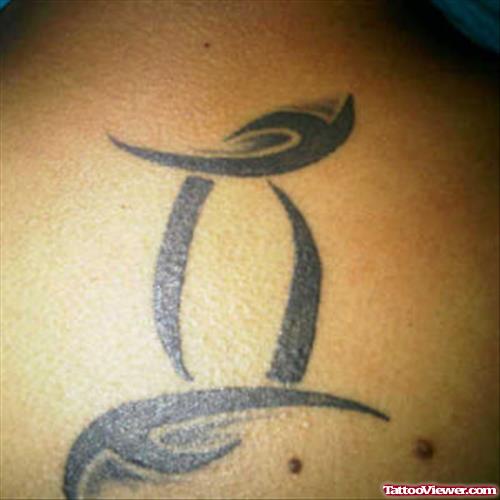 Black Ink Tribal Gemini Tattoo On Back