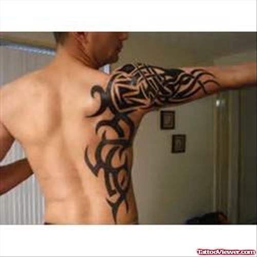 Tribal And Gemini Tattoo On Side And Half Sleeve