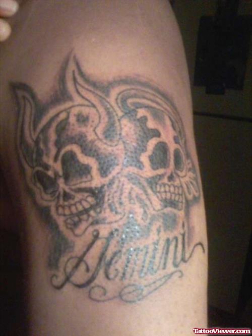 Grey Ink Skull andf Gemini Tattoo